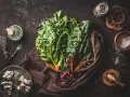 Blettes fraîches, ail, herbes et épices pour une délicieuse recette blette. Huile d'olive et sel complètent les ingrédients.