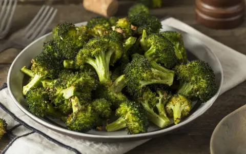 Un plat de brocolis au four, tendres et légèrement caramélisés, prêts à être dégustés.