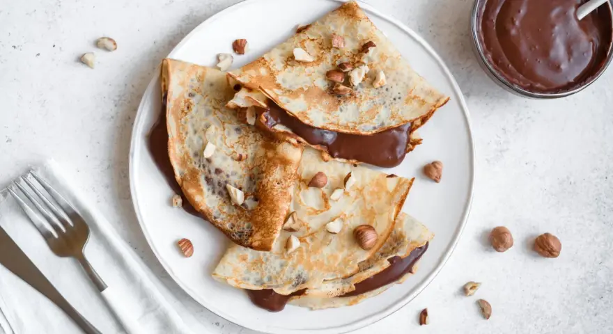 Crêpes garnies de nutella liquide pour crêpe, parsemées de noisettes concassées. Un délice gourmand !