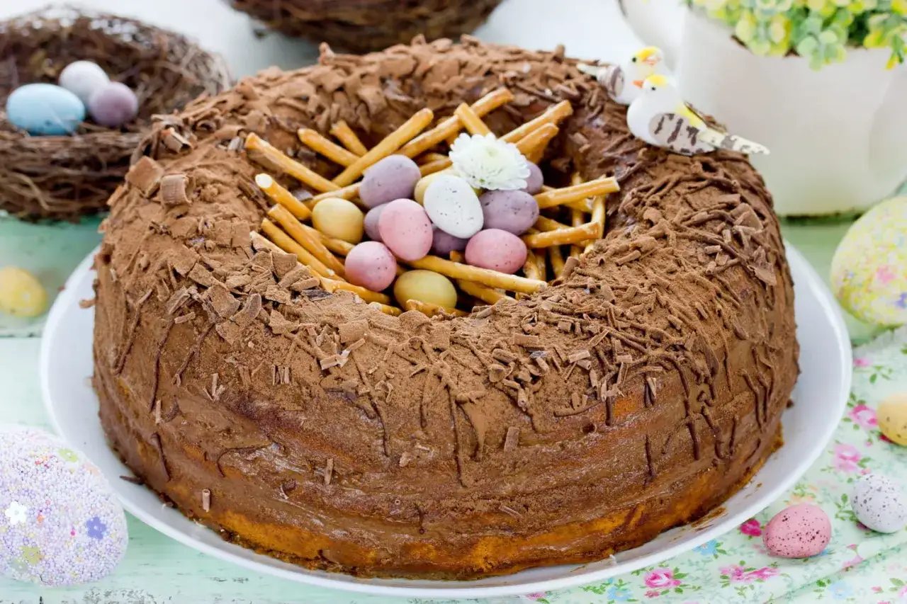 Un délicieux gâteau de Pâques en forme de nid, garni d'œufs en chocolat et de bretzels. Parfait pour célébrer Pâques !